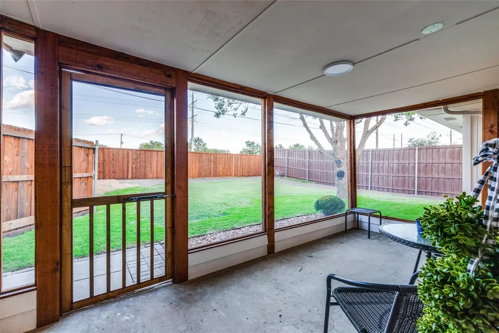 Screened patio built by YourHandyman DFW with a timber frame, screen panels and a finished concrete floor